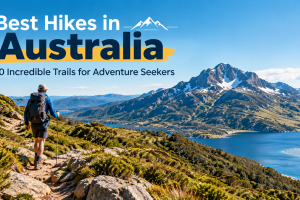 Best hikes in Australia featuring a hiker on a scenic alpine trail beside a mountain lake
